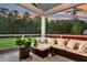 Covered patio with comfortable seating and a view of the backyard and wooded area at 5525 Alpine Dr, Summerville, SC 29483