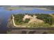 Aerial view of a tranquil coastal area with a walking path near water and marsh views at 601 King Haven Ln, Johns Island, SC 29455