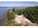 Aerial view of a sandy recreation area surrounded by lush trees, benches, and a fire pit at 601 King Haven Ln, Johns Island, SC 29455