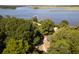 Aerial shot of a peaceful area with a pier, sandy area, trees, and river views at 601 King Haven Ln, Johns Island, SC 29455