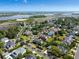 An aerial view shows a neighborhood with lush green trees and manicured lawns, near a river and a bridge at 601 King Haven Ln, Johns Island, SC 29455