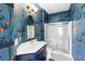 Bathroom features a modern vanity, unique patterned wallpaper, and a glass-enclosed shower at 601 King Haven Ln, Johns Island, SC 29455