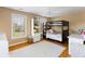 Cozy bedroom featuring a bunk bed, desk, and storage, with hardwood floors and natural light at 601 King Haven Ln, Johns Island, SC 29455
