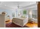 Bright bedroom with tray ceilings, two windows, hardwood floors, and neutral decor at 601 King Haven Ln, Johns Island, SC 29455