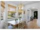 An elegant dining room features a wooden table, white chairs, and a stylish chandelier at 601 King Haven Ln, Johns Island, SC 29455