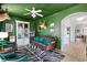 Arched doorway leads into a dark-walled living room with statement furniture and unique decor at 601 King Haven Ln, Johns Island, SC 29455
