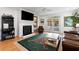 Bright living room features a fireplace, mounted TV, and access to the outdoor patio at 601 King Haven Ln, Johns Island, SC 29455