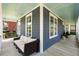 Cozy front porch seating area, perfect for relaxing with its comfortable sofa and view of the lovely neighborhood at 601 King Haven Ln, Johns Island, SC 29455