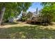 Expansive backyard with a wooden deck, mature trees, and a storage shed at 6242 Fieldstone Cir, Charleston, SC 29414