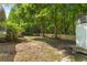 Spacious backyard featuring a wooden fence, trees, and access to a porch at 6242 Fieldstone Cir, Charleston, SC 29414