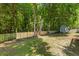 Fenced backyard with mature trees and a storage shed at 6242 Fieldstone Cir, Charleston, SC 29414