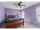 Cozy bedroom with purple walls and a wooden sleigh bed frame at 6242 Fieldstone Cir, Charleston, SC 29414