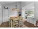 Inviting dining area with stylish lighting fixtures adjacent to the pantry and kitchen at 6242 Fieldstone Cir, Charleston, SC 29414