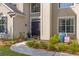 Beautiful home's front door and walkway surrounded by plants and fresh mulch at 6242 Fieldstone Cir, Charleston, SC 29414