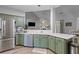 Bright kitchen with stainless steel appliances, green cabinets, and an open layout at 6242 Fieldstone Cir, Charleston, SC 29414