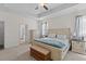 Comfortable primary bedroom featuring neutral carpet, a ceiling fan, and a doorway leading to the primary bath at 6242 Fieldstone Cir, Charleston, SC 29414
