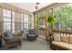 Screened patio with comfortable seating and view of backyard nature at 6242 Fieldstone Cir, Charleston, SC 29414