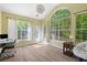Bright sunroom with large windows and a comfortable seating area at 6242 Fieldstone Cir, Charleston, SC 29414