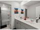 Modern bathroom with double sinks, sleek cabinets, a large mirror, and a shower, offering a clean and stylish design at 630 Jancus St, Charleston, SC 29414