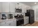 A kitchen features sleek appliances, granite counters, stylish cabinets, and subway tile backsplash at 630 Jancus St, Charleston, SC 29414