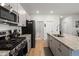 Modern kitchen boasts stainless steel appliances, granite countertops, and a view to the dining area at 630 Jancus St, Charleston, SC 29414