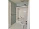 Bathroom with seashell wallpaper, shower/tub combo and tile flooring at 70 Legare St, Charleston, SC 29401