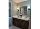 Bathroom with dual sink vanity, seashell wallpaper and tile flooring at 70 Legare St, Charleston, SC 29401