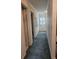 Hallway with blue carpet, adjacent to a closet and a window at 70 Legare St, Charleston, SC 29401