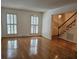 Spacious living room with hardwood floors, plantation shutters, and staircase access at 70 Legare St, Charleston, SC 29401