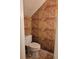 Compact half bathroom features a toilet and wallpaper with intricate designs at 70 Legare St, Charleston, SC 29401