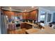 Well-appointed kitchen with stainless steel appliances, wooden cabinets and a view to the living room at 7019 Lanier St, Hanahan, SC 29410