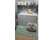Bright laundry room featuring washer, dryer, utility sink, and storage shelves at 7019 Lanier St, Hanahan, SC 29410