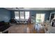 Open-concept living space with bright blue walls, and lots of seating at 7019 Lanier St, Hanahan, SC 29410