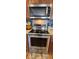 Kitchen with stainless steel KitchenAid oven and microwave with ample counter space and wooden cabinetry at 7019 Lanier St, Hanahan, SC 29410