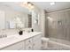 Modern bathroom featuring double vanity, tiled shower with glass door, and neutral color palette at 714 N Hickory St # 13, Summerville, SC 29483