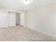 Large bedroom with neutral walls and carpeting featuring multiple doorways and a ceiling light at 714 N Hickory St # 13, Summerville, SC 29483