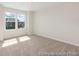 Bedroom showcasing large windows, providing ample natural light, with neutral walls and carpeting at 714 N Hickory St # 13, Summerville, SC 29483