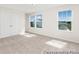 Bright bedroom with carpet, large windows, and a double door closet maximizing natural light at 714 N Hickory St # 13, Summerville, SC 29483