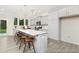 Bright, open kitchen featuring gray cabinets, a large island with seating, and stainless steel appliances at 714 N Hickory St # 13, Summerville, SC 29483