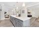Open-concept kitchen with an island that includes storage, stainless steel appliances and wood flooring at 714 N Hickory St # 13, Summerville, SC 29483
