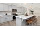 Well-equipped kitchen features gray cabinets, a spacious island with bar stools, and stainless steel appliances at 714 N Hickory St # 13, Summerville, SC 29483