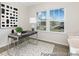 Bright office space with a modern desk, artwork, and large windows providing natural light at 714 N Hickory St # 13, Summerville, SC 29483