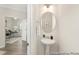 Elegant powder room featuring a pedestal sink, oval mirror, and stylish lighting fixture at 714 N Hickory St # 13, Summerville, SC 29483