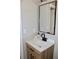 Modern bathroom with a wood vanity cabinet, white countertop, and black faucet at 7774 Ginger Ln, North Charleston, SC 29420