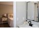 Well lit bathroom vanity next to an open doorway and an inviting bedroom at 7774 Ginger Ln, North Charleston, SC 29420