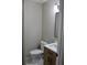 Small half bath features include a white toilet, white sink and a stylish vanity at 7774 Ginger Ln, North Charleston, SC 29420