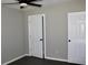 Spacious bedroom with light gray walls, ceiling fan, and a closet at 7774 Ginger Ln, North Charleston, SC 29420