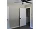 Neutral bedroom showcasing gray walls, a ceiling fan, and doors leading to other rooms at 7774 Ginger Ln, North Charleston, SC 29420