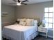 Cozy bedroom featuring a queen-sized bed, ceiling fan, and ample natural light from the window at 7774 Ginger Ln, North Charleston, SC 29420