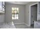 Bright dining area with a granite countertop, large window, and marble floors at 7774 Ginger Ln, North Charleston, SC 29420